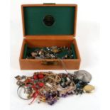 A quantity of costume jewellery to include brooches and necklaces.