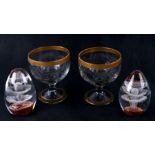 A pair of etched glass bowls with gilded decoration, 14cms high; together with two Art glass