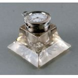 An Edwardian novelty silver and glass inkwell, the lid inset with a pocket watch with subsidiary