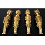 A set of four cast gilt brass figural furniture mounts, each 39cms high (4).