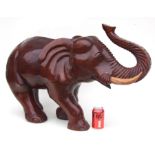 A modern carved wooden figure of an elephant. 57cm high