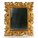 A carved giltwood wall mirror, overall 35 by 41cms.