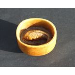 An ivory netsuke in the form of a carp in a footed bowl, 4cms wide.