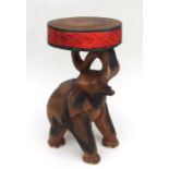 A modern coffee table with elephant figure support. 47cm high