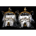 A pair of mirror backed gilt metal and crystal drop wall lights, 24cms high (2).Condition ReportNo