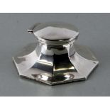 An early 20th century silver Capstan inkwell of flared octagonal form, marks rubbed, 12cms wide.