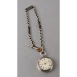 A silver cased open faced fob watch on an Albert chain.Condition Reportdoes not seem to be