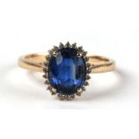 A 9ct gold ring set with a large oval sapphire surrounded by small diamonds, approx UK size 'N', 2.