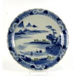 A Japanese blue & white charger decorated with a mountainous landscape, 48cms diameter.