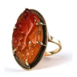 A 14ct gold ring set with a pierced agate panel, probably Chinese, approx UK size 'K', 6.6g.