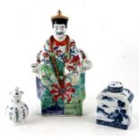 A Chinese pottery figure of a seated emperor, 32cms high; together with a blue & white tea caddy and