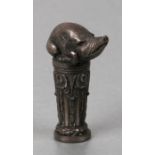 A white coloured metal desk seal in the form of a wild boar sitting atop a column with initialled