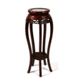 A Chinese hardwood jardiniere stand with marble inset top, 30cms diameter.