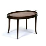 A mahogany oval butlers tray table on tapering legs. 76cm wide