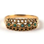 An 18ct gold ring set with five small turquoise cabochons, approx UK size 'O', 3g.
