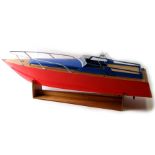 A large scale scratch built wooden speed boat with electric motor, on a stand, 82cms long.