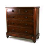 A Victorian mahogany chest of drawers with two short and three long graduated drawers, on bun