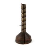 A 19th century spiral steel candlestick with ejector, on a wooden plinth, 21cms high.