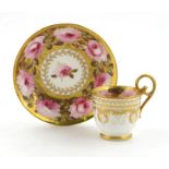An early 19th century Coalport cup and saucer, finely painted with a large band of pink roses and
