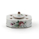 A 19th century Strasbourg faïence inkwell and cover, set with four small holes around a central