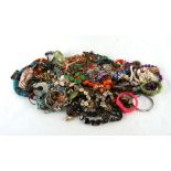 A large quantity of costume jewellery to include bead necklaces.