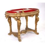 A 19th century giltwood and gesso display table with four wells above figural supports, 110 by