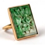 A 14ct gold ring set with a large pierced jade panel, approx UK size 'N', 11.8g.