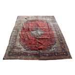 A Persian Kashan woollen hand knotted carpet with foliate design on a red ground, 408 by 310cms (