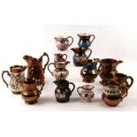 A quantity of late Victorian lustre jugs, the largest 17cms high.