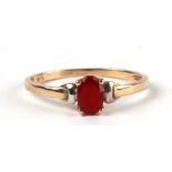 A 9ct gold dress ring set with an oval red stone. Approx. UK size L. 0.8g