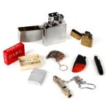 A group of collectable cigarette lighters including a brass Zippo and a Zippo style lighter,