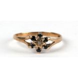 A 9ct gold diamond and sapphire cluster ring. Approx. UK size N. 1.4g
