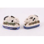 A pair of Staffordshire pottery recumbent rabbits, 9cms long (2).