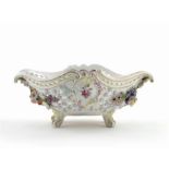 A 19th century Continental porcelain basket , moulded with rococo panels and applied with flowers,