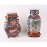 A Chinese famille rose baluster vase decorated with figures within panels and foliate scrolls, on