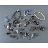 A quantity of silver and white metal jewellery to include bracelets and brooches.