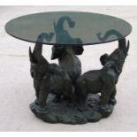 A modern decorative coffee table with three elephant support base. 60cm high. 80cm diameterCondition