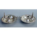 A pair of silver plated chambersticks with snuffers, 19cms diameter (2).