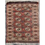 A Persian rug with repeated guls on a red ground, 150 by 101cms.