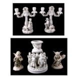 A pair of white glazed continental porcelain candelabra with blue crossed swords mark to the