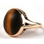 A 14ct gold ring set with a large oval tiger's eye cabochon, approx UK size 'K', 3.7g.