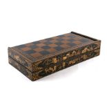 A chinoiserie lacquer games box with chess board exterior and backgammon interior containing