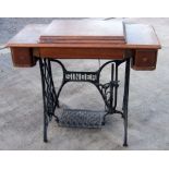 A Singer treadle sewing machine with cast iron base, 92cms wide.