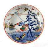 A Chinese footed porcelain dish decorated with a landscape scene with cranes, 22cms diameter.