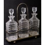 A silver plated three-bottle decanter stand with three cut glass decanters, 30cms high.