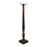 An Edwardian mahogany torchere with tapered reeded column on a stepped square base, 130cms high.