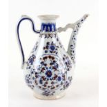 An Italian Iznik style Cantagalli wine ewer decorated with fruiting foliate scrolls, 29cms high.