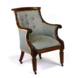 An early 19th century upholstered mahogany library chair