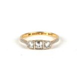 An 18ct gold and platinum three-stone diamond ring with triple square setting, approx UK size 'L',
