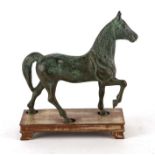 A bronze sculpture depicting a horse, 20cms long, mounted on a hardwood stand.